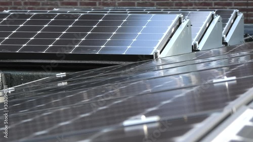 Solar panels in an array on flat rooftop photo