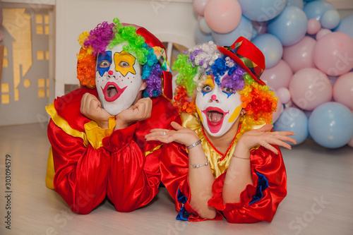 Funny clowns from the circus. Clown boy and clown girl show emotions © izida1991