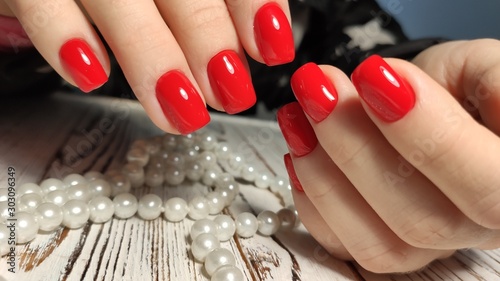 Foto Manicured nails colored with red nail polish