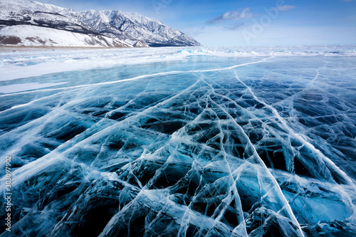 View of beautiful drawings on ice from cracks and bubbles of deep gas on surface of Baikal lake in winter, Russia photo