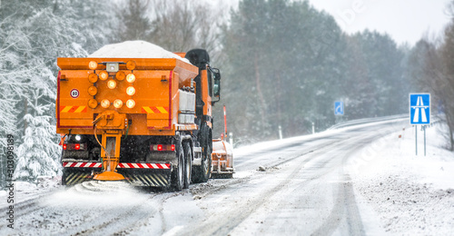 Tableau sur toile Snow plow on highway salting road