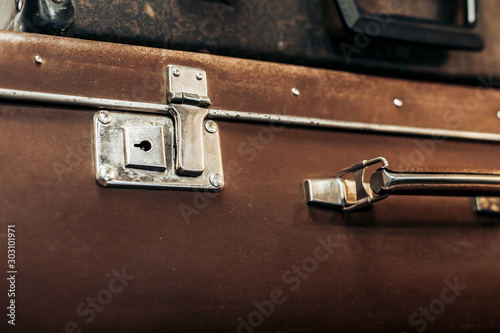 Vintage vintage black and brown suitcases lie on a shelf