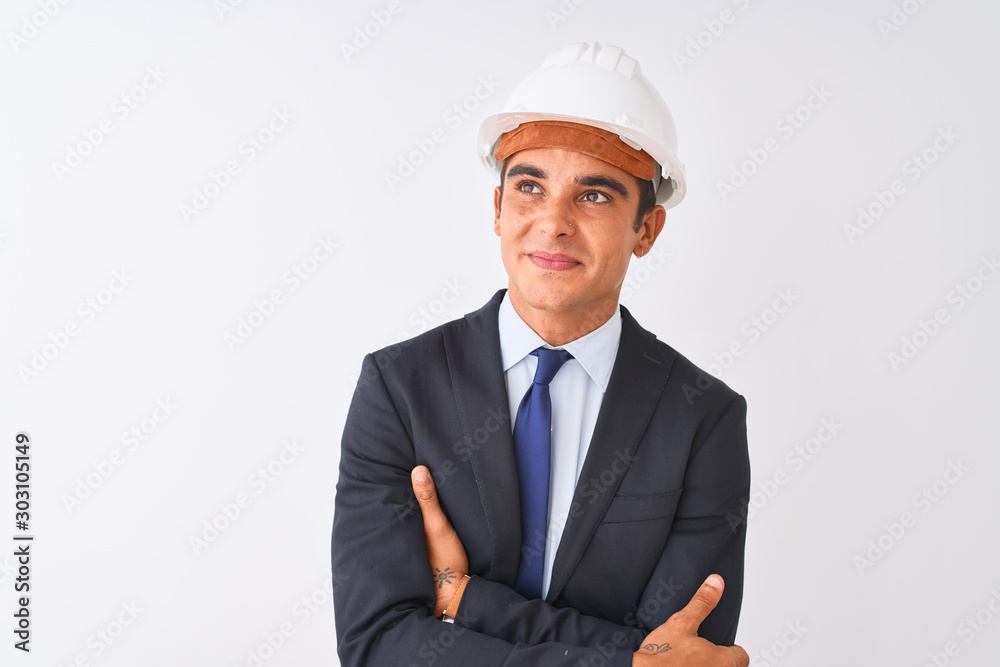 Young handsome architect man wearing suit and helmet over isolated white background smiling looking to the side and staring away thinking.