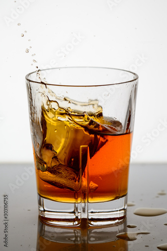 splashing whiskey in a glass on the background3
