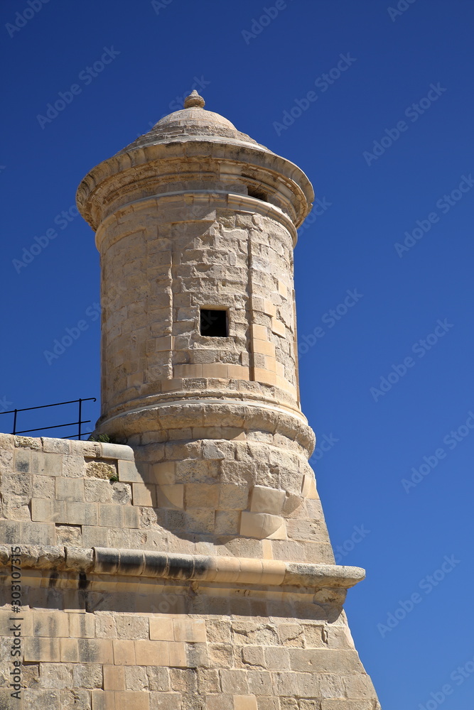 tower of medieval wall in Valetta city, malta, against blue clear sky