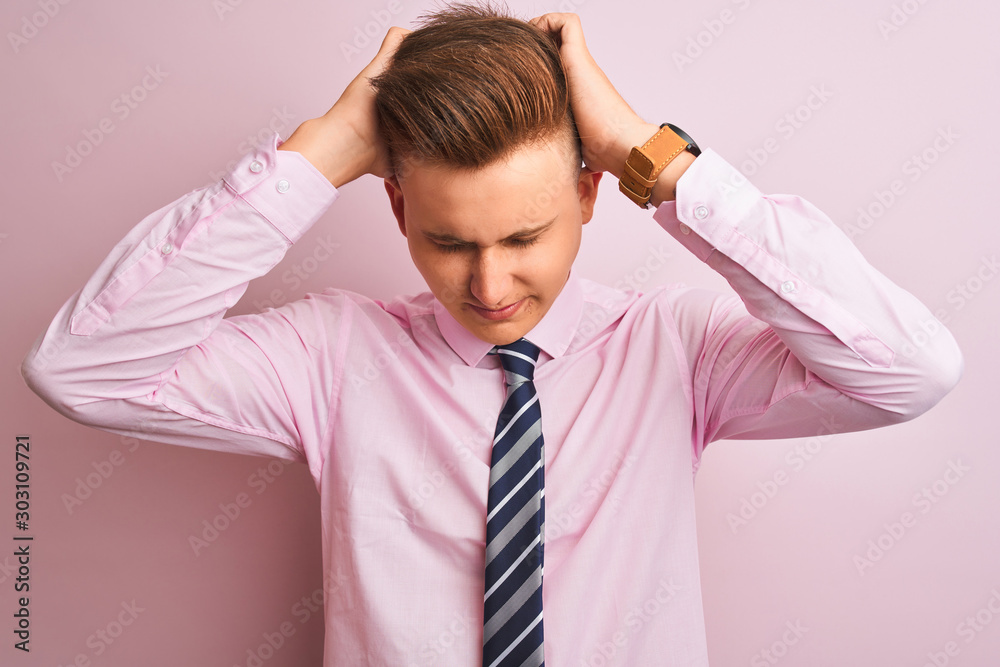 Young handsome businessman wearing shirt and tie standing over isolated pink background suffering from headache desperate and stressed because pain and migraine. Hands on head. Young handsome businessman wearing shirt and tie standing over isolated pink background suffering from headache desperate and stressed because pain and migraine. Hands on head.