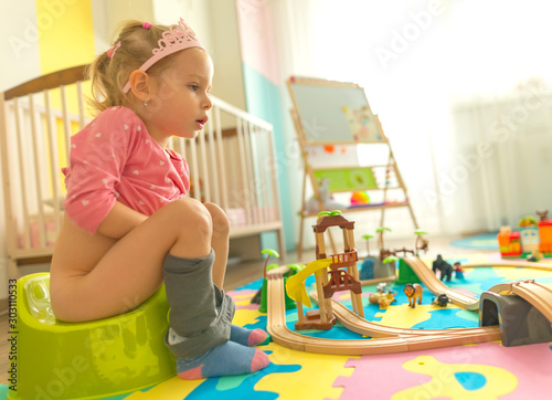 girl pushing on potty