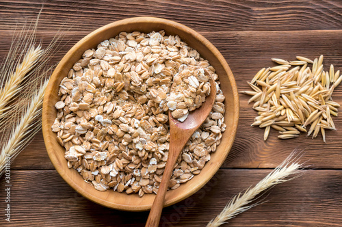 Oats, oat flakes and ear on wooden table, top view. Top view.  photo