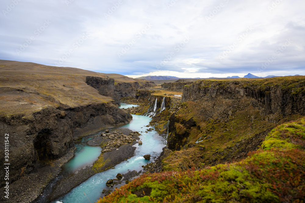 Obraz premium Beautiful landscape of Sigoldugljufur canyon with many small waterfalls and the blue river in Highlands of Iceland