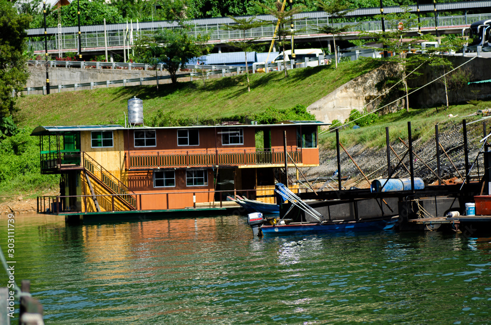 boathouse floating near the lakeshore.it is main transportation at Banding Lake located in Perak State, Malaysia for tourist enjoy exploring the lake boathouse floating near the lakeshore.it is main transportation at Banding Lake located in Perak State, Malaysia for tourist enjoy exploring the lake