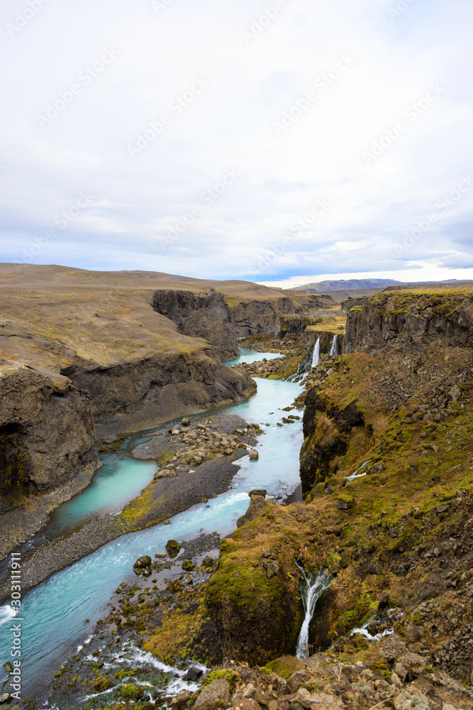 Obraz premium Beautiful landscape of Sigoldugljufur canyon with many small waterfalls and the blue river in Highlands of Iceland