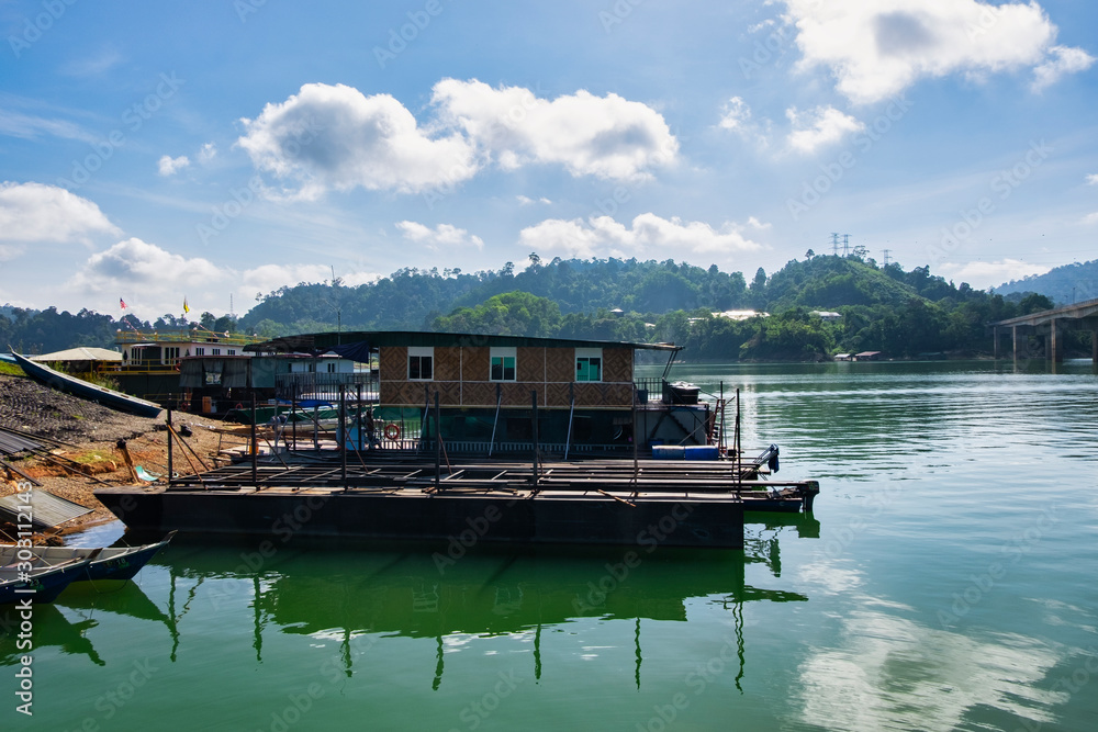 boathouse floating near the lakeshore.it is main transportation at Banding Lake located in Perak State, Malaysia for tourist enjoy exploring the lake