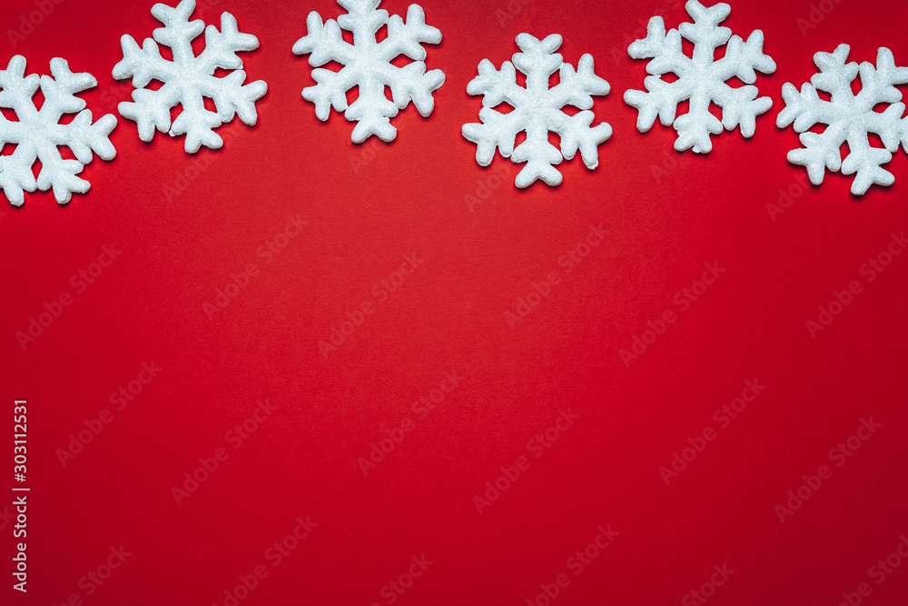 red background with white snowflakes and stars. place for text with christmas decorations red background with white snowflakes and stars. place for text with christmas decorations