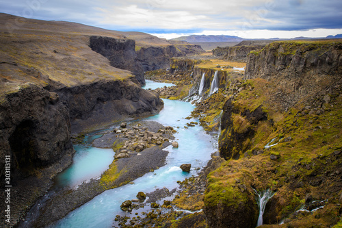 Beautiful landscape of Sigoldugljufur canyon with many small waterfalls and the blue river in Highlands of Iceland photo