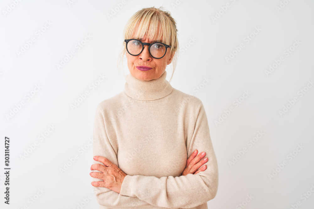 Middle age woman wearing turtleneck sweater and glasses over isolated white background skeptic and nervous, disapproving expression on face with crossed arms. Negative person. Middle age woman wearing turtleneck sweater and glasses over isolated white background skeptic and nervous, disapproving expression on face with crossed arms. Negative person.
