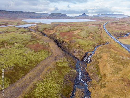 Iceland. Aerial view on the mountain, field, bridge and river. Landscape in the Iceland at the day time. Landscape from drone. Travel - image.
