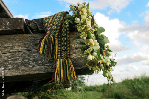 folk belt and flower crown, symbols of Latvian identity