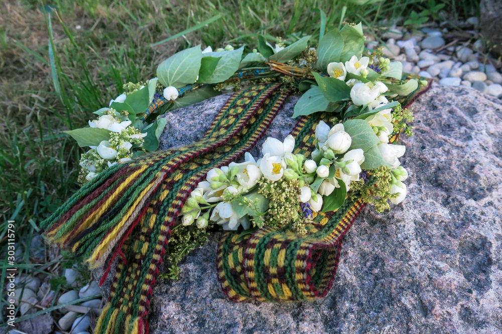 folk belt and flower crown, symbols of Latvian identity