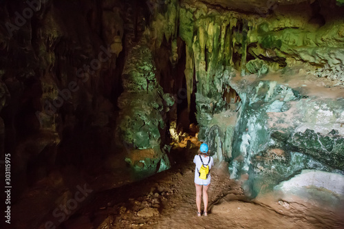 Tourist inside Putri Termenung cave, Misool, Raja Ampat South, Papua, Indonesia photo