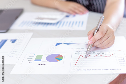 Business financial and investment concepts, people using calculators and data graphs to analyze company revenue and expenditures in preparation for the planning of presentations, finances concept
