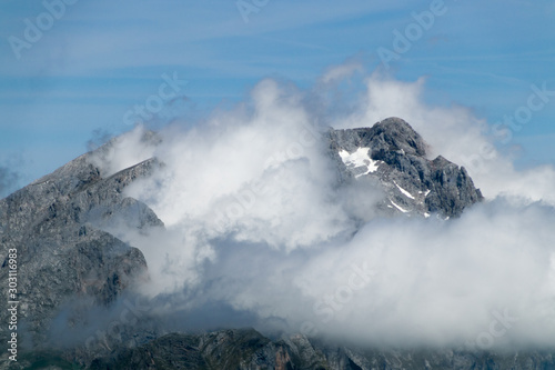 Clouds around a high mountain peak