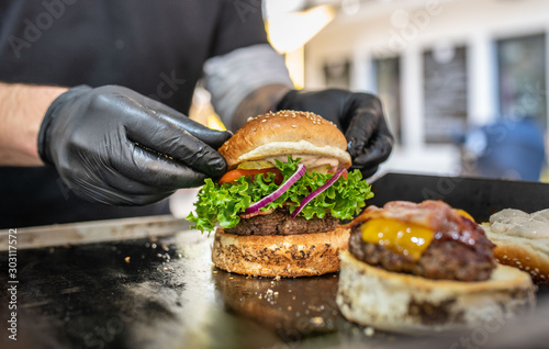 Preparing of fresh burger with potato fries chips on grill photo
