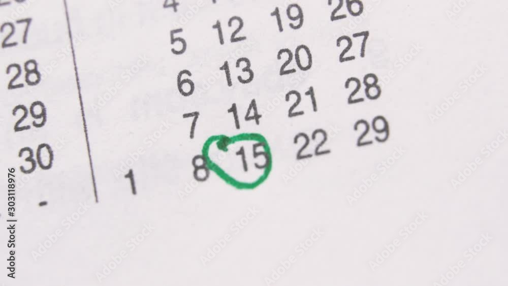 The green Marker Circled 15th Date On The Calendar, Signing a day on a calendar by green pen . The green Marker Circled 15th Date On The Calendar, Signing a day on a calendar by green pen .