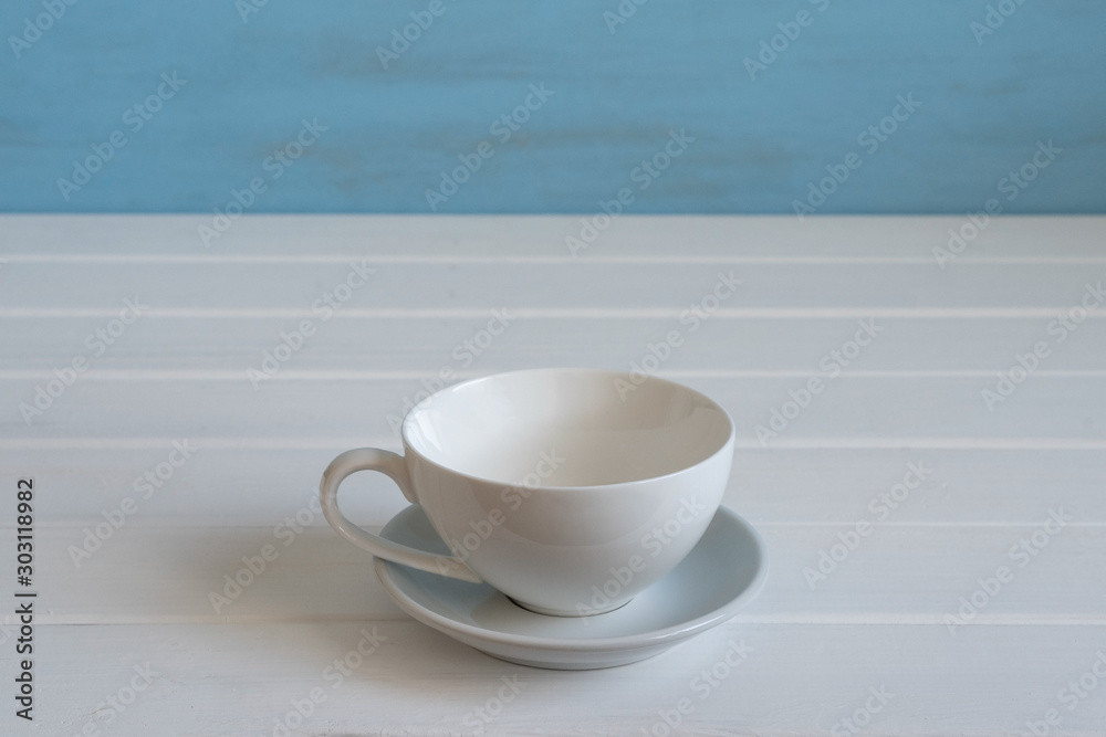 Empty tea cup on wooden background. Free space for text.