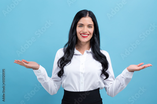 Tablou pe pânză Young woman with her arms outstretched on a blue background
