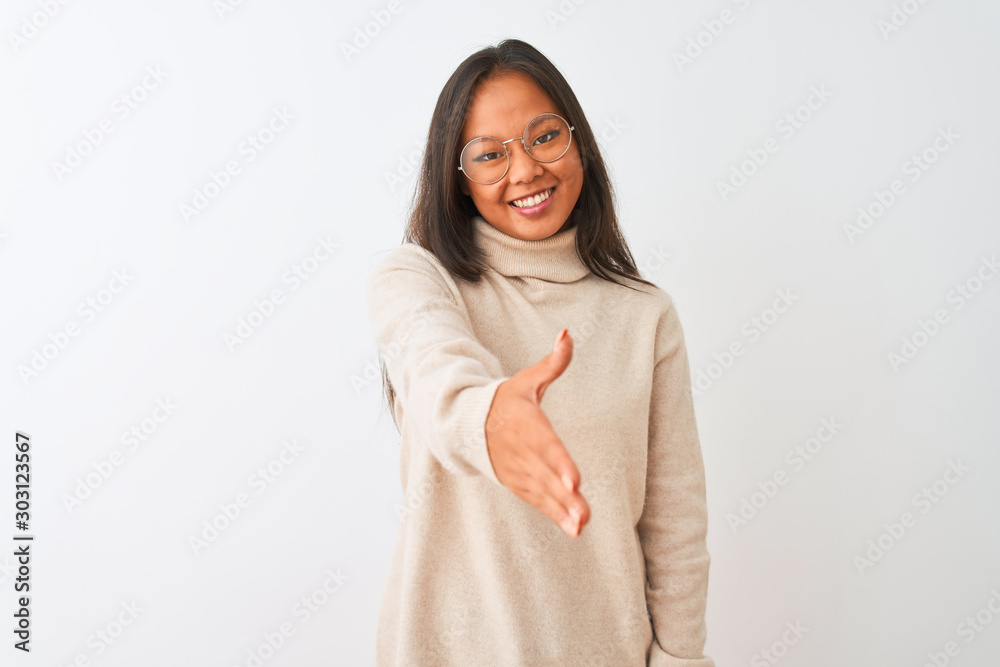 Young chinese woman wearing turtleneck sweater and glasses over isolated white background smiling friendly offering handshake as greeting and welcoming. Successful business. Young chinese woman wearing turtleneck sweater and glasses over isolated white background smiling friendly offering handshake as greeting and welcoming. Successful business.