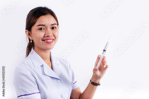 Syringe on hands of a nurse  woman doctor holding syringe isolated on white
