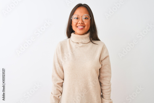 Young chinese woman wearing turtleneck sweater and glasses over isolated white background with a happy and cool smile on face. Lucky person.