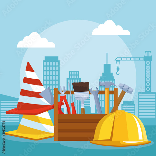 traffic cones with tools box and safety helmet over under construction scenery background photo