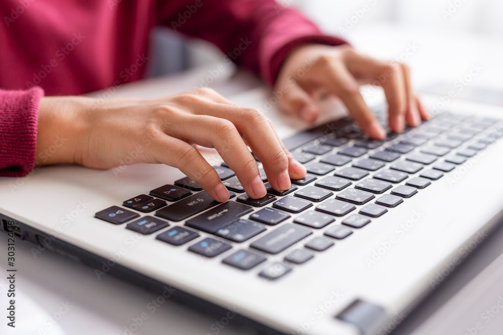 Hands of businesswoman working on a laptop at the office. Close-up Hands of businesswoman working on a laptop at the office. Close-up