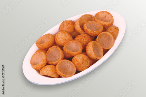 Fried and Spicy Moon Cup, Vatka, Katori, Moon Chips, Snacks or Fryums (Snacks Pellets) White background. selective focus - Image photo