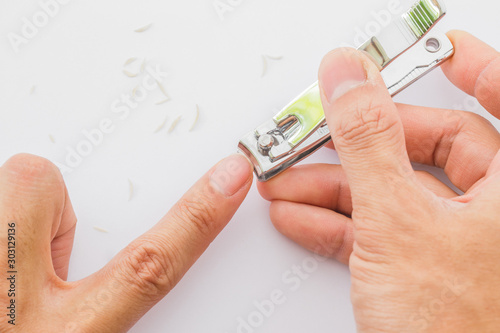 Man cuts his nails with tweezers on a white background. Nail care illustration For their good hygiene.