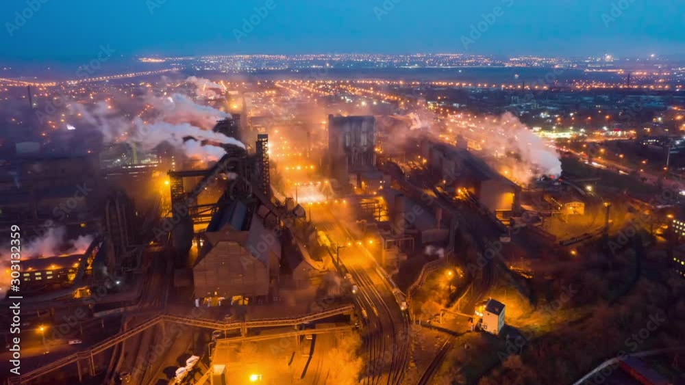 Aerial view. Emission to atmosphere from industrial pipes. Smokestack pipes shooted with drone. Night scene