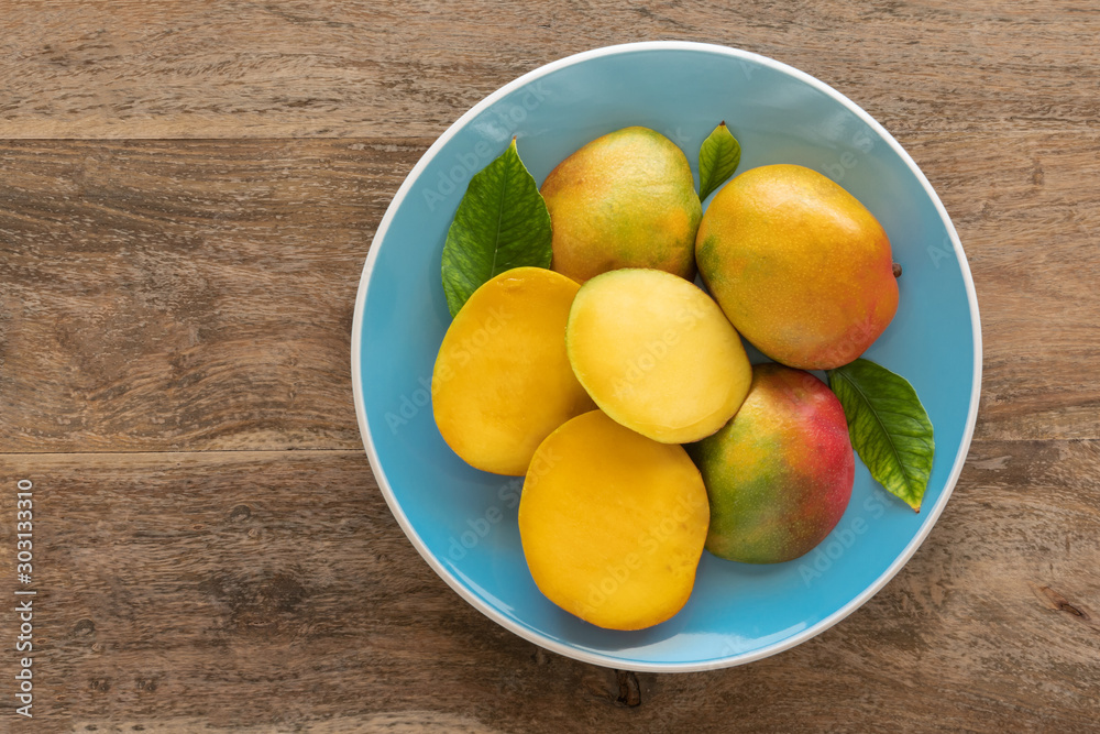Mango fruits on a blue plate.