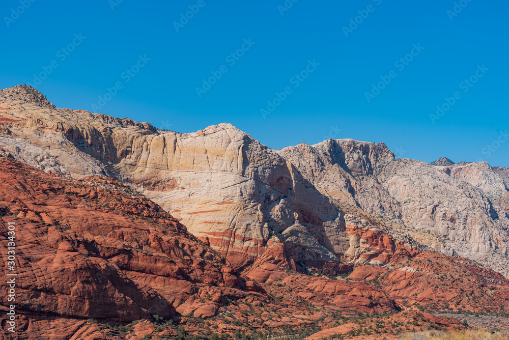 Low angle landscape pf white and orange stone hillside at Snow Canyon State Park in Utah