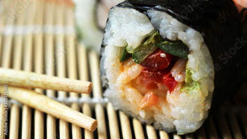 Fotografie Sushi roll and wooden stics so close