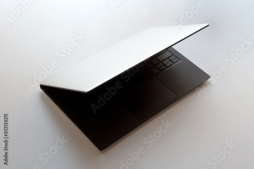 Half closed laptop computer isolated on white background