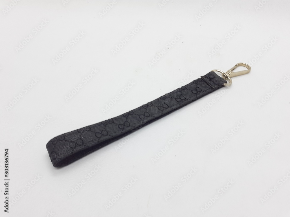 Black and Gold Color Metallic Artistic Simple Elegant from Synthetic Fabric Materials with Beautiful Pattern Key Chain in White Isolated Background Black and Gold Color Metallic Artistic Simple Elegant from Synthetic Fabric Materials with Beautiful Pattern Key Chain in White Isolated Background