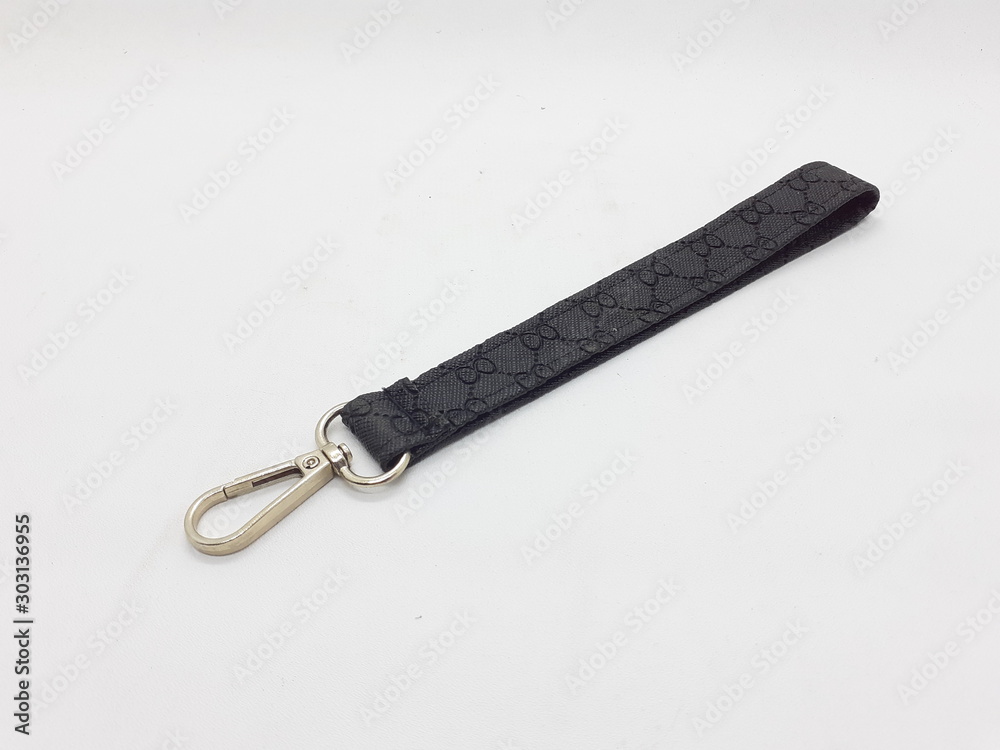 Black and Gold Color Metallic Artistic Simple Elegant from Synthetic Fabric Materials with Beautiful Pattern Key Chain in White Isolated Background Black and Gold Color Metallic Artistic Simple Elegant from Synthetic Fabric Materials with Beautiful Pattern Key Chain in White Isolated Background