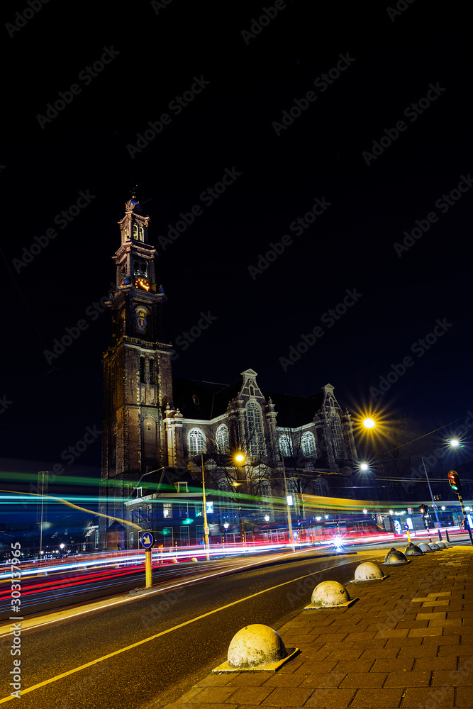 A cathedral and light trails of a train and cars in Amsterdam 