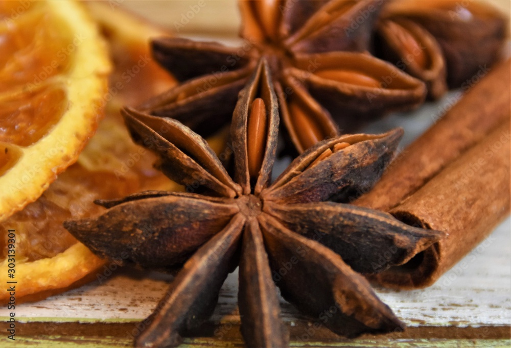 dried slices of orange, cinnamon rolls and anise