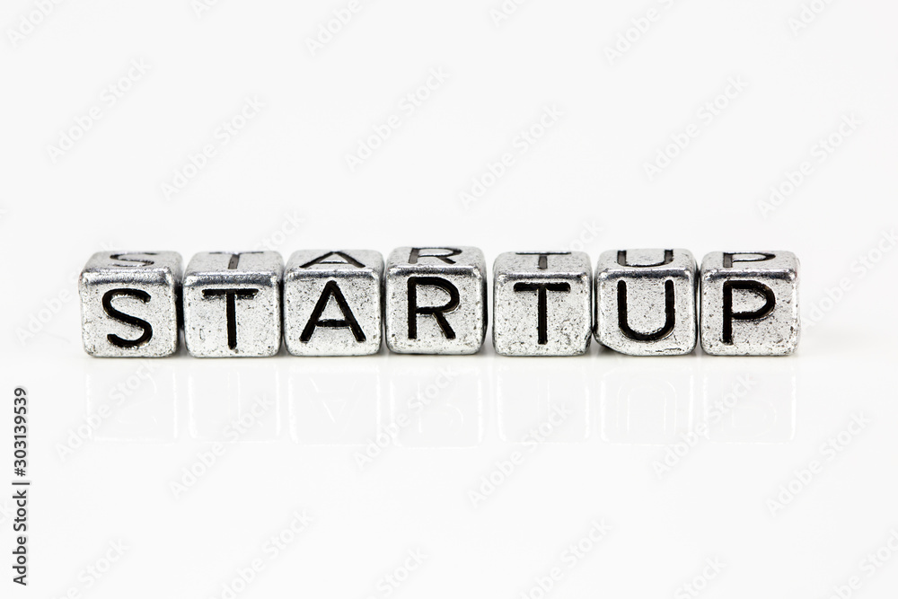 Startup concept with cubic metal letters Startup concept with cubic metal letters
