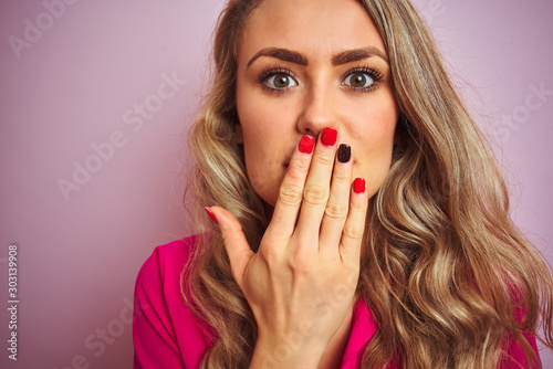 Young beautiful woman wearing elegant shirt standing over pink isolated background cover mouth with hand shocked with shame for mistake, expression of fear, scared in silence, secret concept