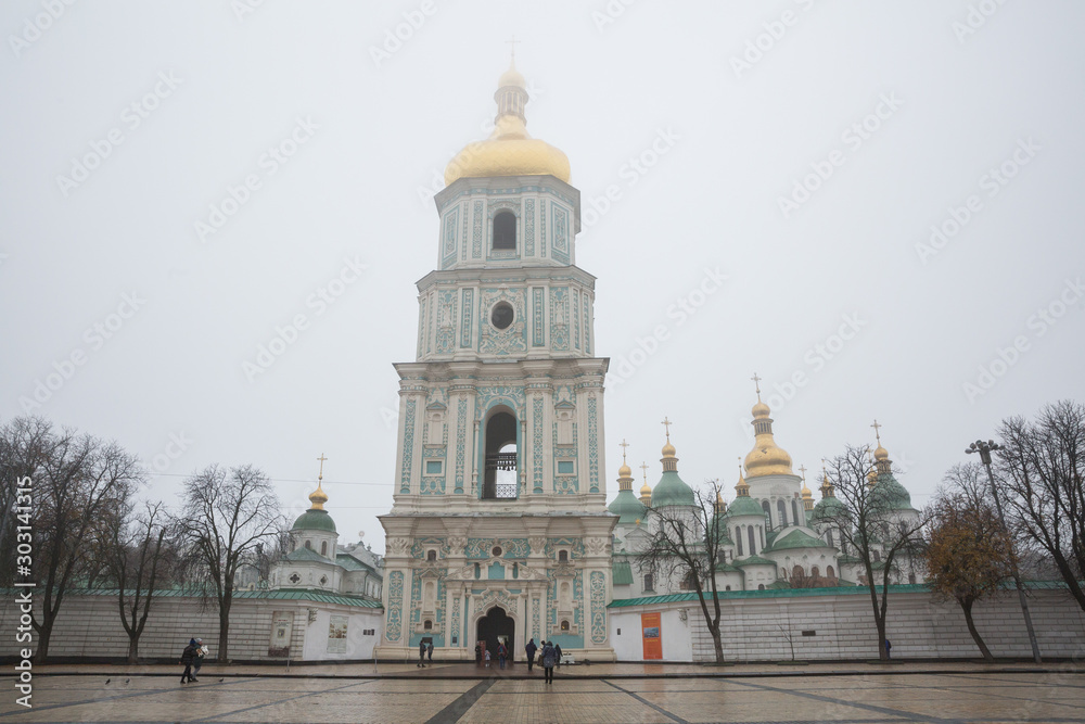 City Kiev, Ukrainian. Morning mist and church in the city center. Passers-by and tourists walk down the street.