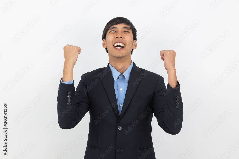 Excited young business Asian man raising his fists with happy delighted face, celebrating success isolated on white background. Excited young business Asian man raising his fists with happy delighted face, celebrating success isolated on white background.