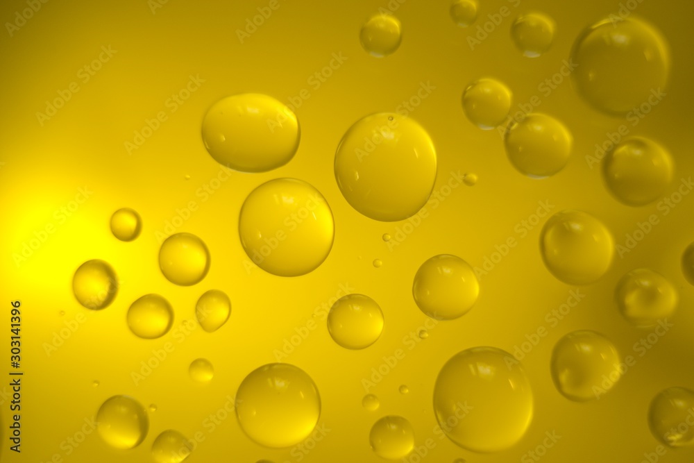 Yellow cooking Oil bubble and drops on water for background.